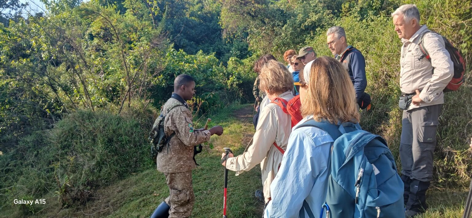 Uniformed guide briefing a group of trekkers on a forest trail