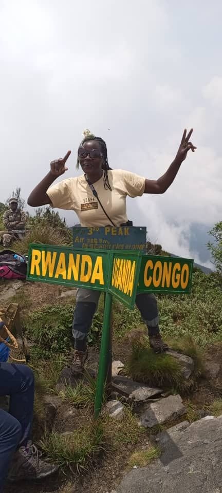 Three-border summit marker in the Virunga region, illustrating the practical cross-border geography that shapes Kigali and southern Bwindi routing.